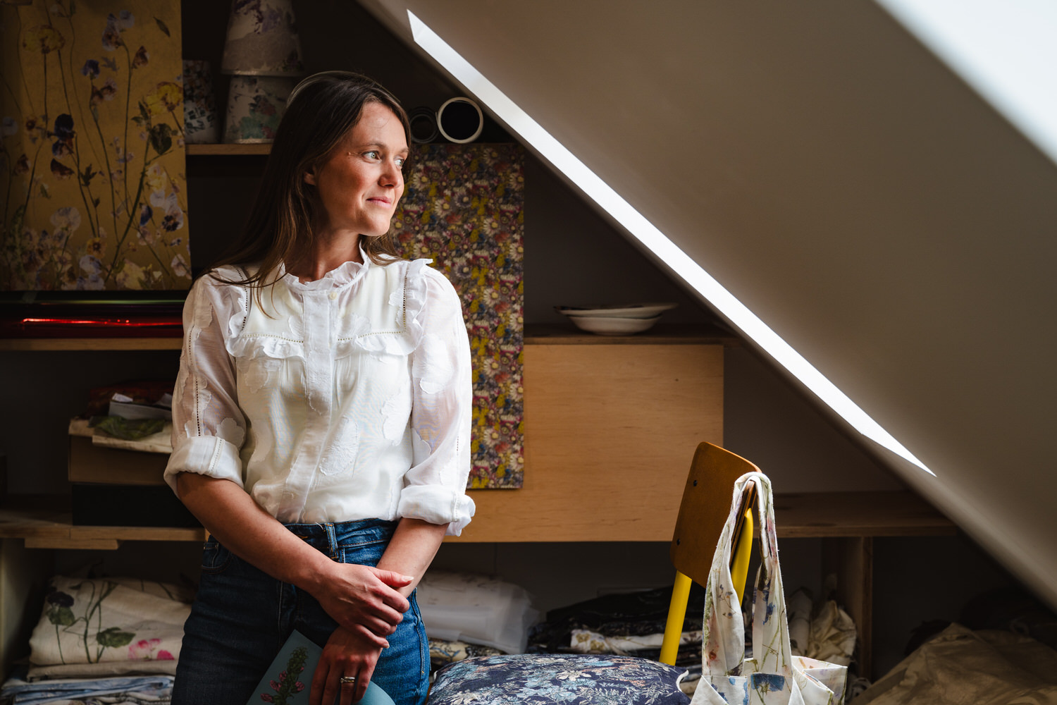 Personal brand image of artist looking out of the window in her studio in rutland